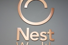 Brass custom 3D letters raised from the wall for Nest