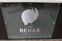 Brushed aluminium cut out letters Rehab-