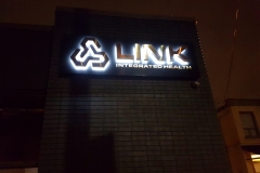 LED illuminated from behind titanium brushed gold letters on black metal box for LINK