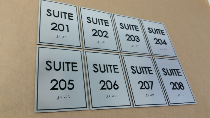 Custom suites brushed aluminium signs.