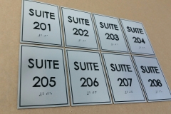 Custom suites brushed aluminium signs.