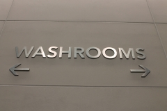 Stainless steel raised washroom signs