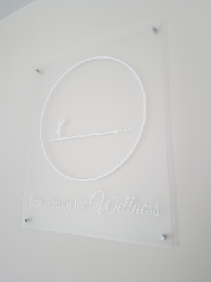 Frosted-acrylic-with-white-vinyl-graphics-reception-sign