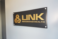 Reception sign brushed gold 3D letters on aluminium panel installed raised from the wall for LINK