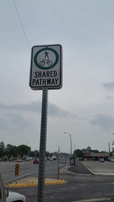 Reflective shared pathway sign
