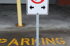 No-parking-signs-with-post-on-concrete-base